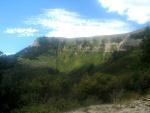 Narrow winding road with a switchback cut straight into the rock.